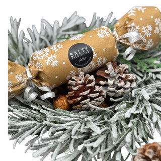 This a shot of the 2025 Salty Provisions Mystery flavor wrapped and sitting on a festive holiday wreath.