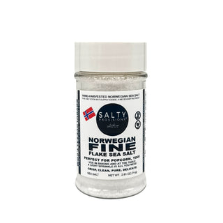 A plastic shaker bottle of NORWEGIAN FINE Flake Sea Salt with a white label by Salty Provisions, clear salt visible inside the bottle, and a white cap.