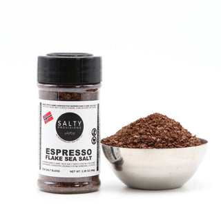 A shaker bottle labeled 'ESPRESSO FLAKE SALT' beside a bowl of the Espresso salt made by Salty Provisions.