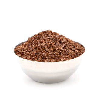 A shaker bottle labeled 'ESPRESSO FLAKE SALT' beside a bowl of the Espresso salt made by Salty Provisions.