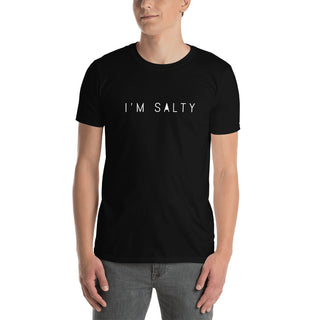 A person wearing a black short-sleeve unisex t-shirt with the text 'I'M SALTY' printed on the front.