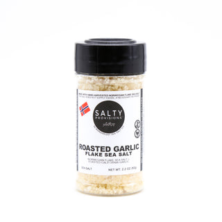 A plastic shaker bottle of Roasted Garlic Flake Sea Salt with a black lid. Hand-harvested from the Norwegian Sea and infused with California Garlic by Salty Provisions.